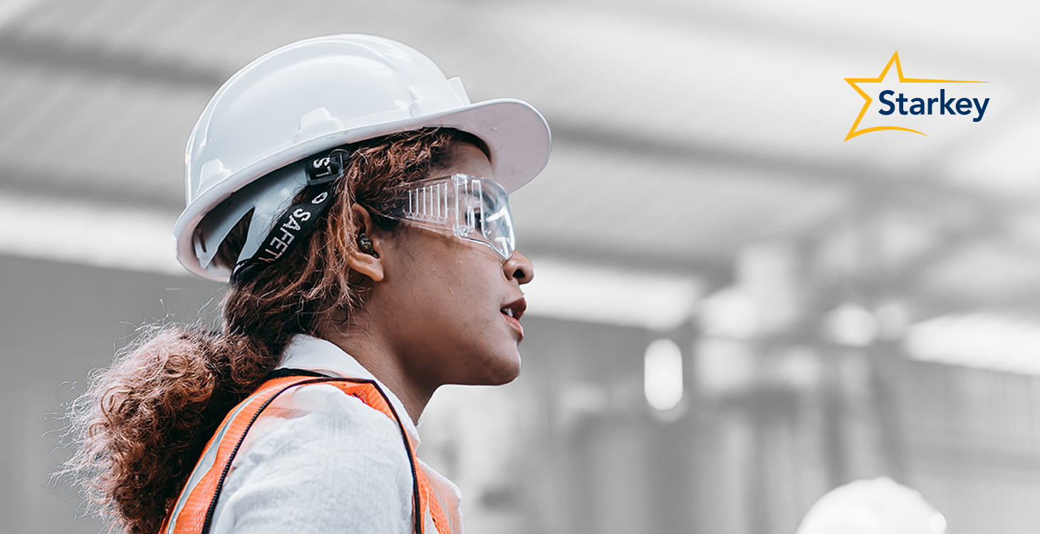 Image of a female construction or factory worker wearing hearing protection devices